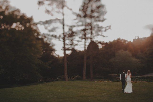 Weddings & Functions illustrated by newly weds standing outside a forest at dusk