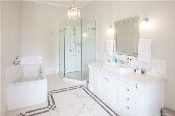 experiences at Elgin Vintners illustrated by Browne Suite en suite bathroom view of bath, shower and cabinets