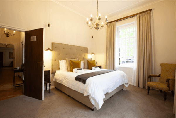 experiences at Elgin Vintners illustrated by Hahn Family Suite bedroom view from room corner to bed and door