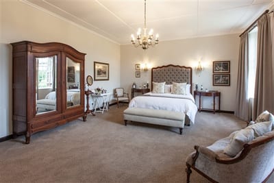 experiences at Elgin Vintners illustrated by Syfret Honeymoon Suite accommodation antique bedroom wardrobe and bed