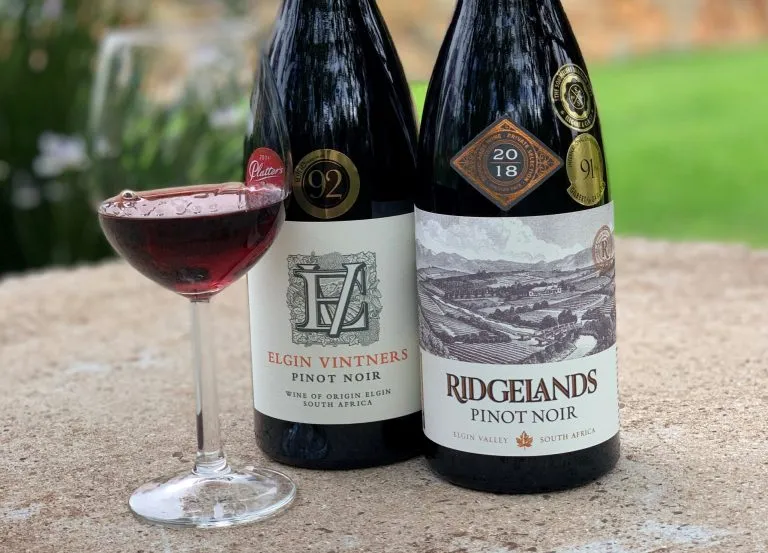 10 Interesting Facts About Pinot Noir illustrated by 2 bottles of wine and glass Ridgelands Pinot Noir and EV Pinot Noir