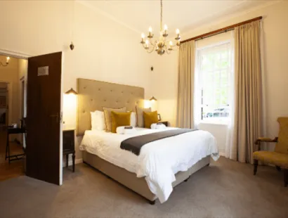 experiences at Elgin Vintners illustrated by Hahn Family Suite bedroom view from room corner to bed and door